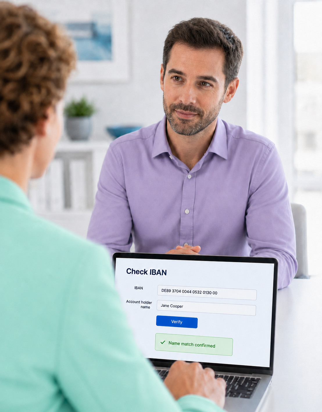 Advisor showing an IBAN check on a laptop to a client