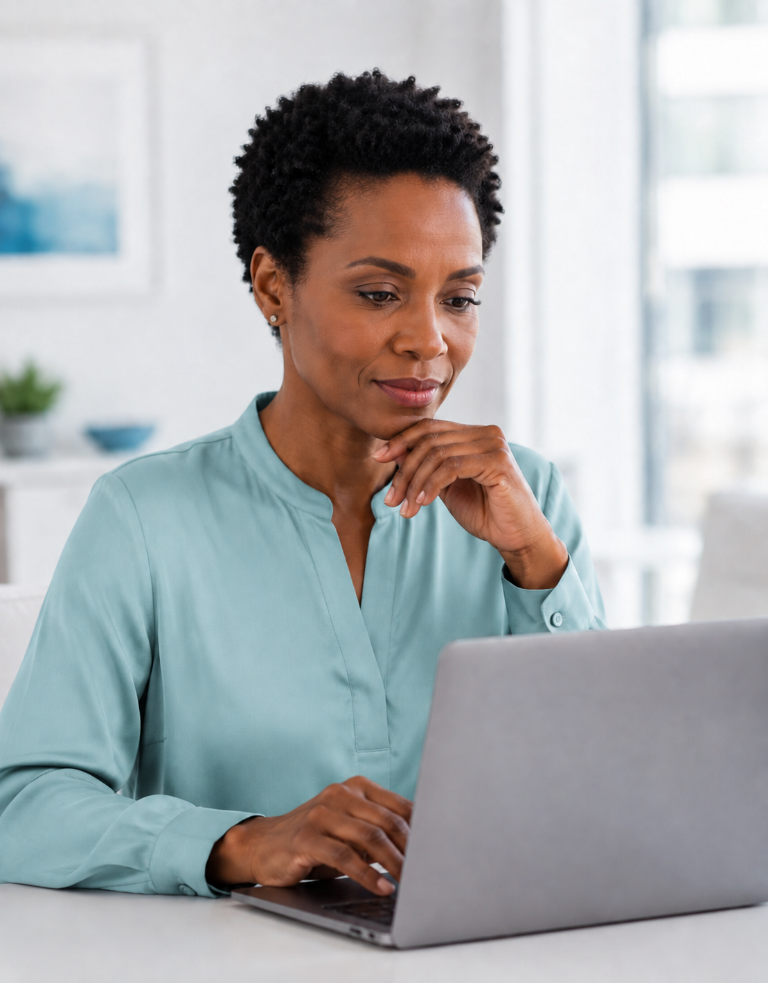 Woman reviewing her finances on a laptop with Wealth Check