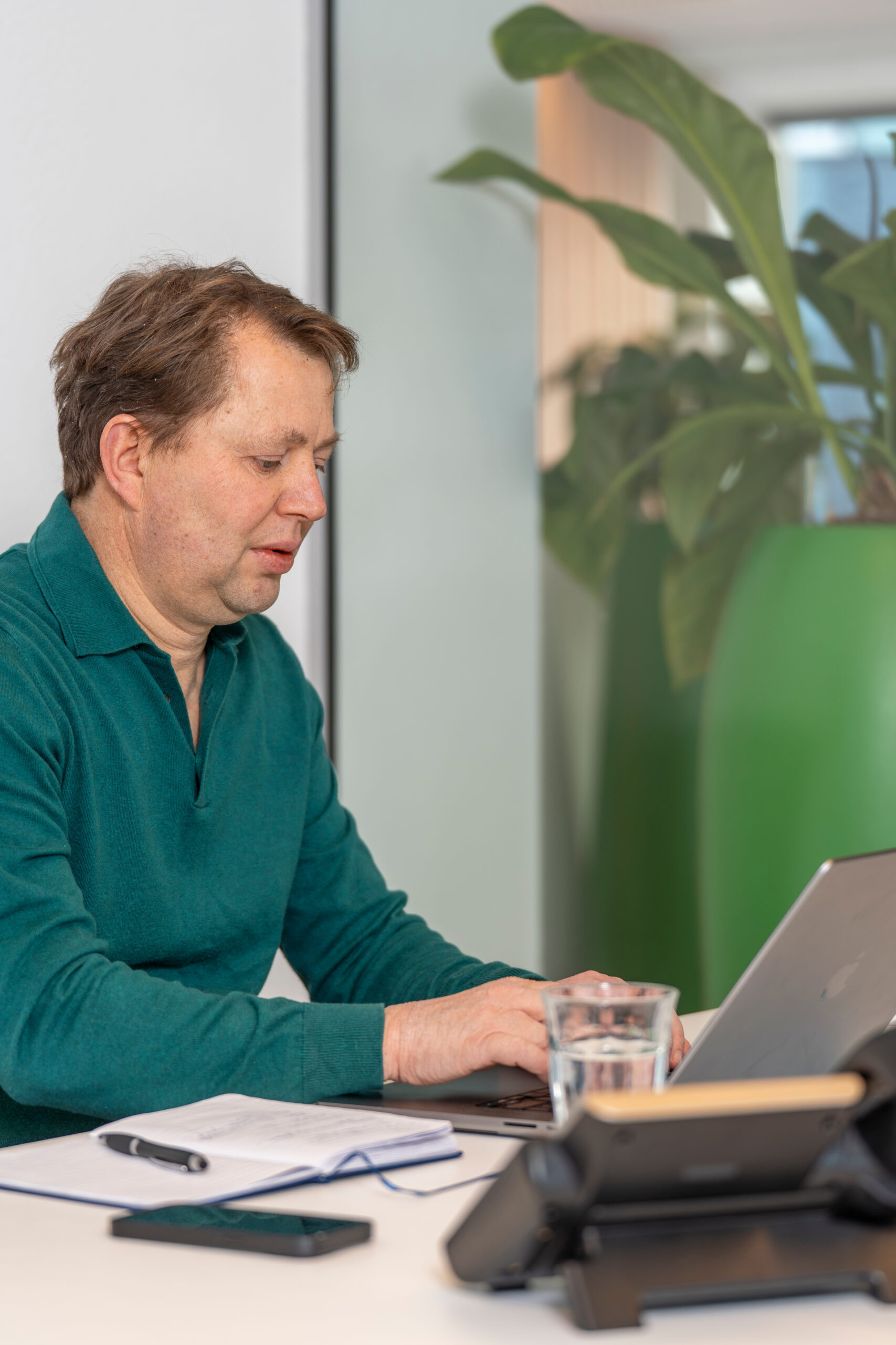 Bluem team member working on a laptop in an office